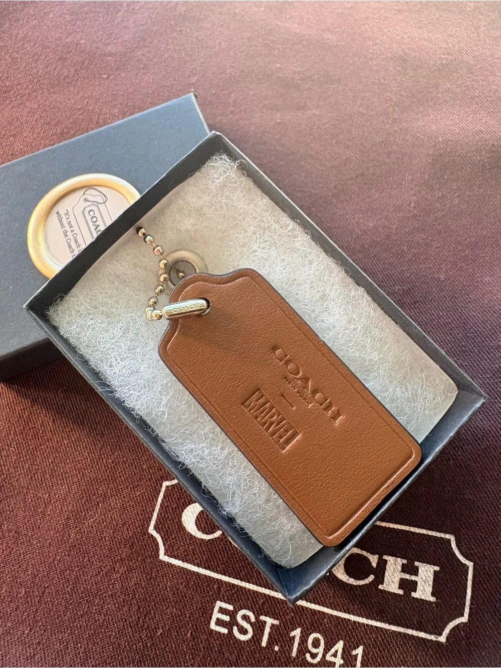 🦸♀️ Coach x MARVEL Ltd Ed Saddle Brown Leather HangTag Bag Charm | 2.375” - Picture 1 of 7